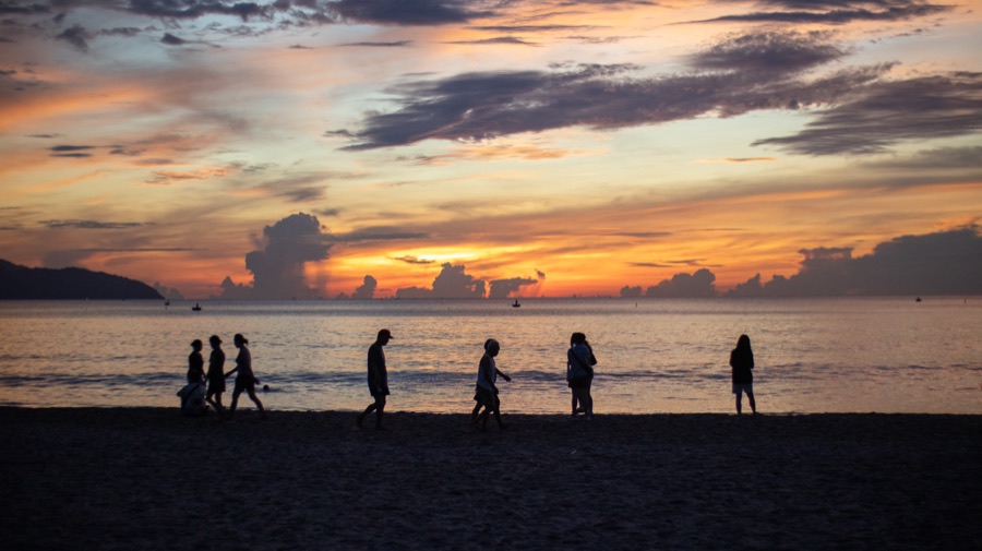 Silhouettes on the beach at sunset