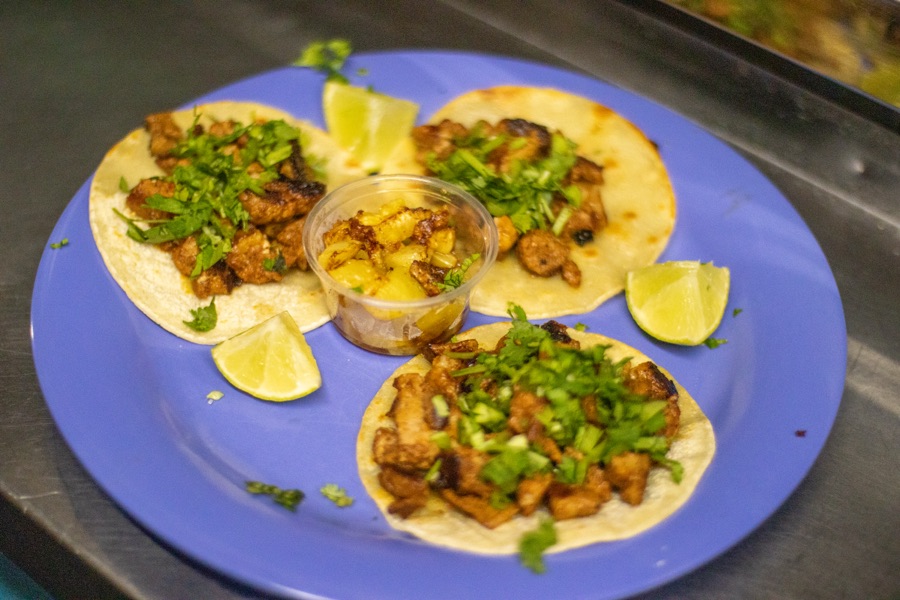 Street tacos plated on a dark table